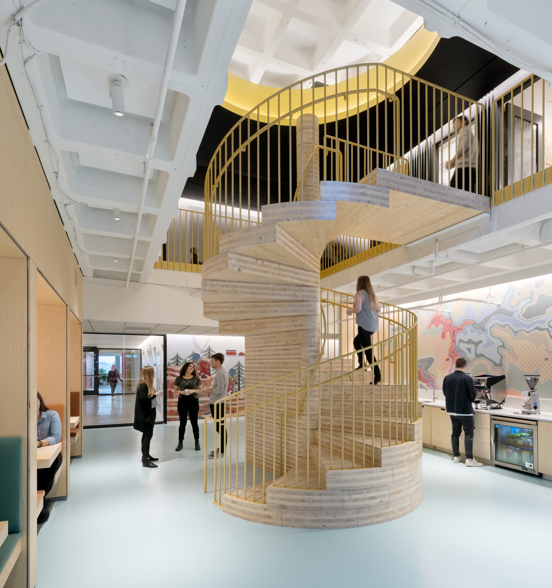 Kendall Square Workspace, wood spiral stair with mustard yellow railing